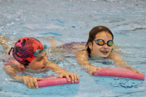 swimmers playing in the pool together